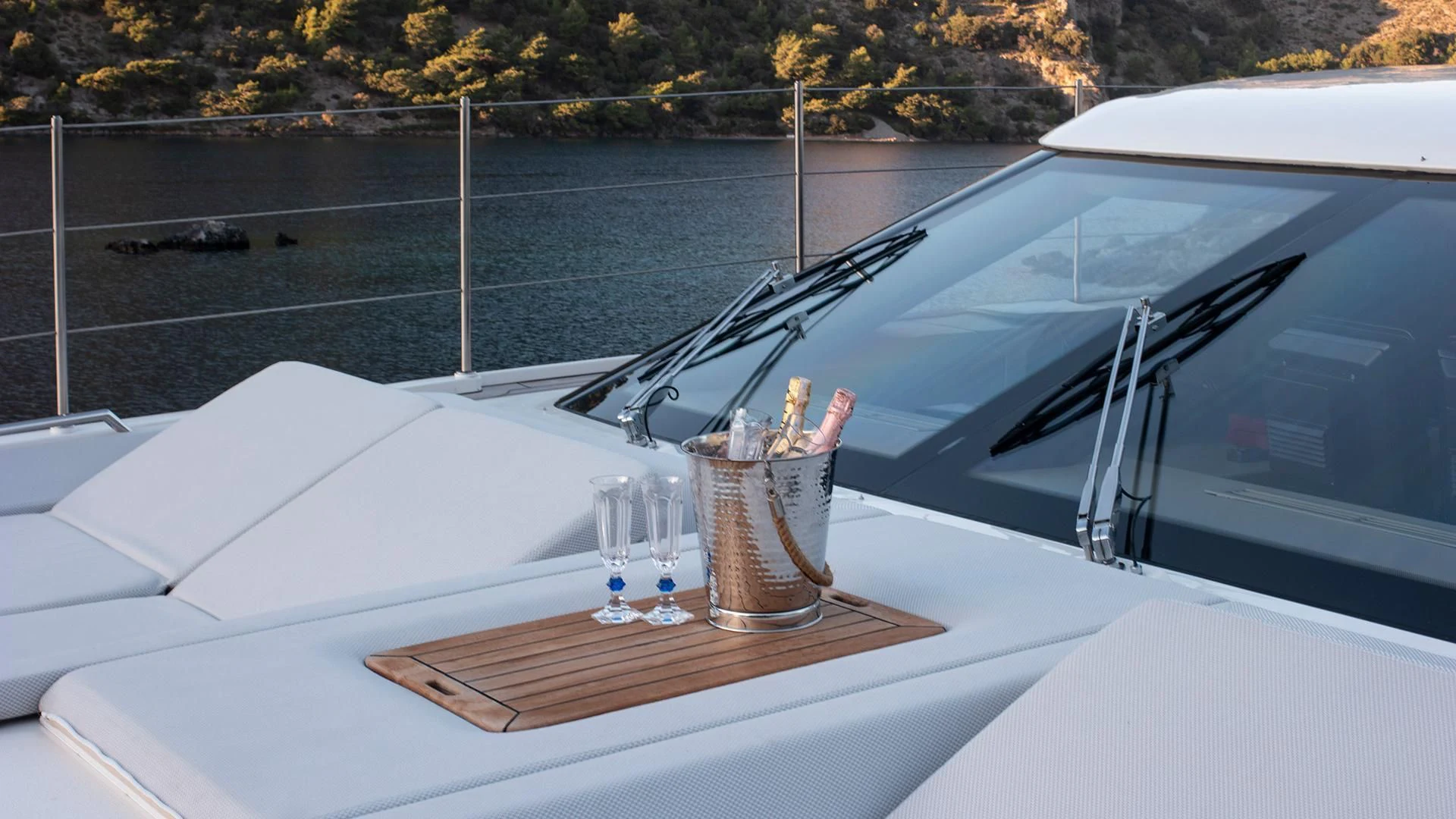 a boat with a glass table and a bottle of wine on a dock aboard MORNING STAR Yacht for Charter