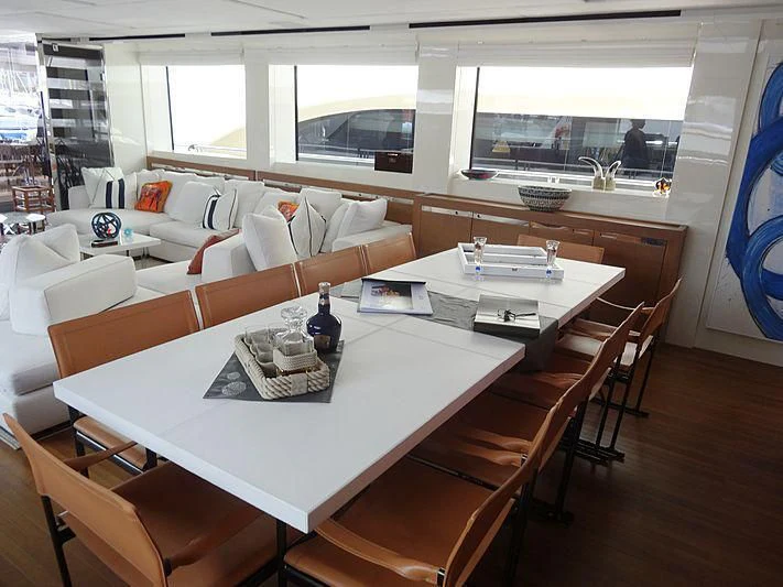 a dining room with a large window aboard MORNING STAR Yacht for Charter