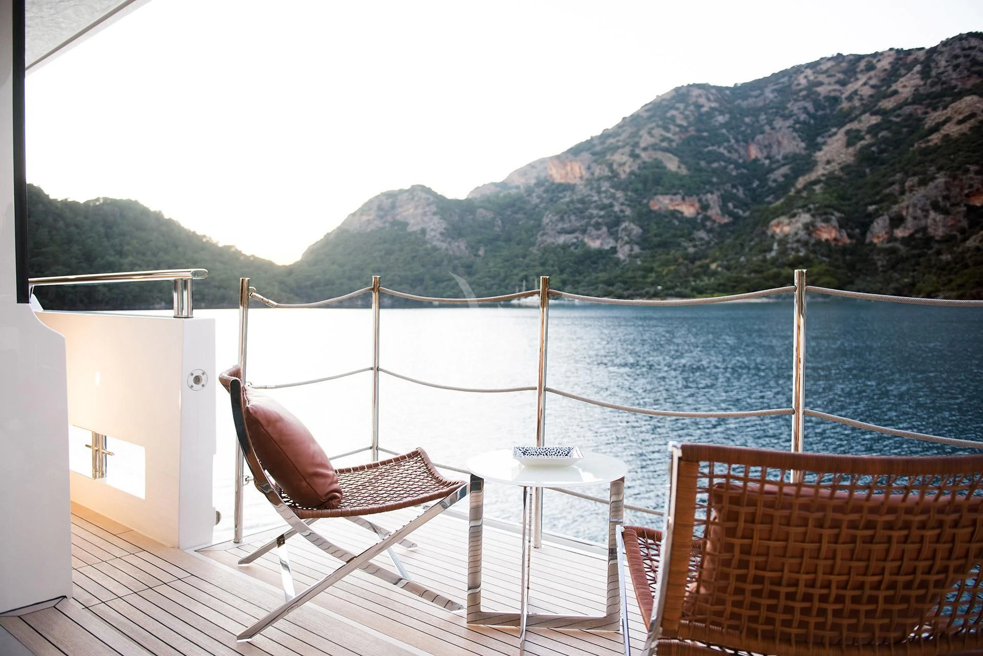 a deck with chairs on it by a body of water aboard MORNING STAR Yacht for Charter