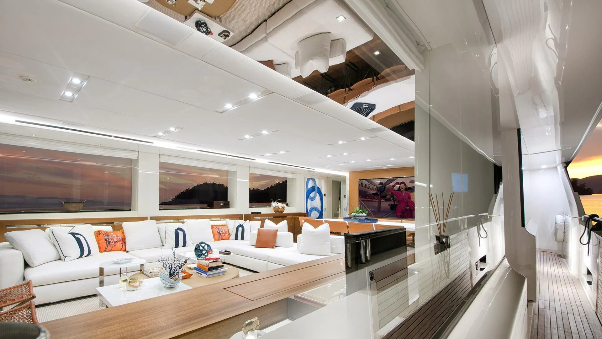 a room with a large white couch and a table with chairs aboard MORNING STAR Yacht for Charter