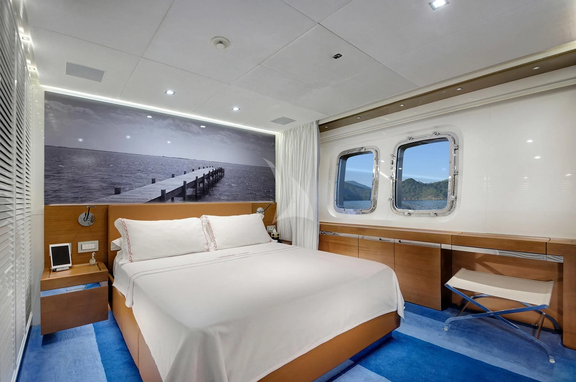a room with a bed and a mirror aboard MORNING STAR Yacht for Charter
