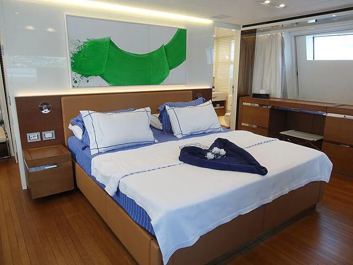 a bed with blue sheets aboard MORNING STAR Yacht for Charter