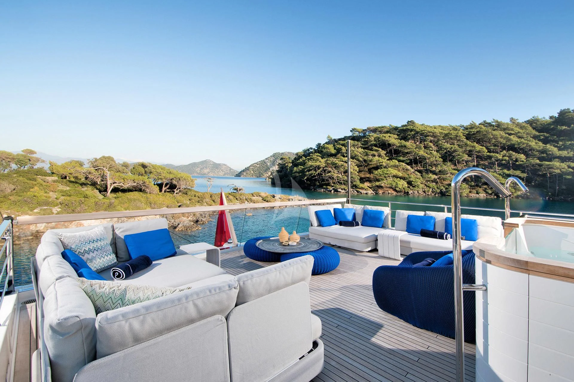 a deck with a pool and a view of the mountains aboard MORNING STAR Yacht for Charter