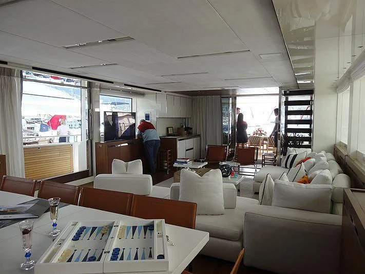 a room with a table chairs and a window aboard MORNING STAR Yacht for Charter