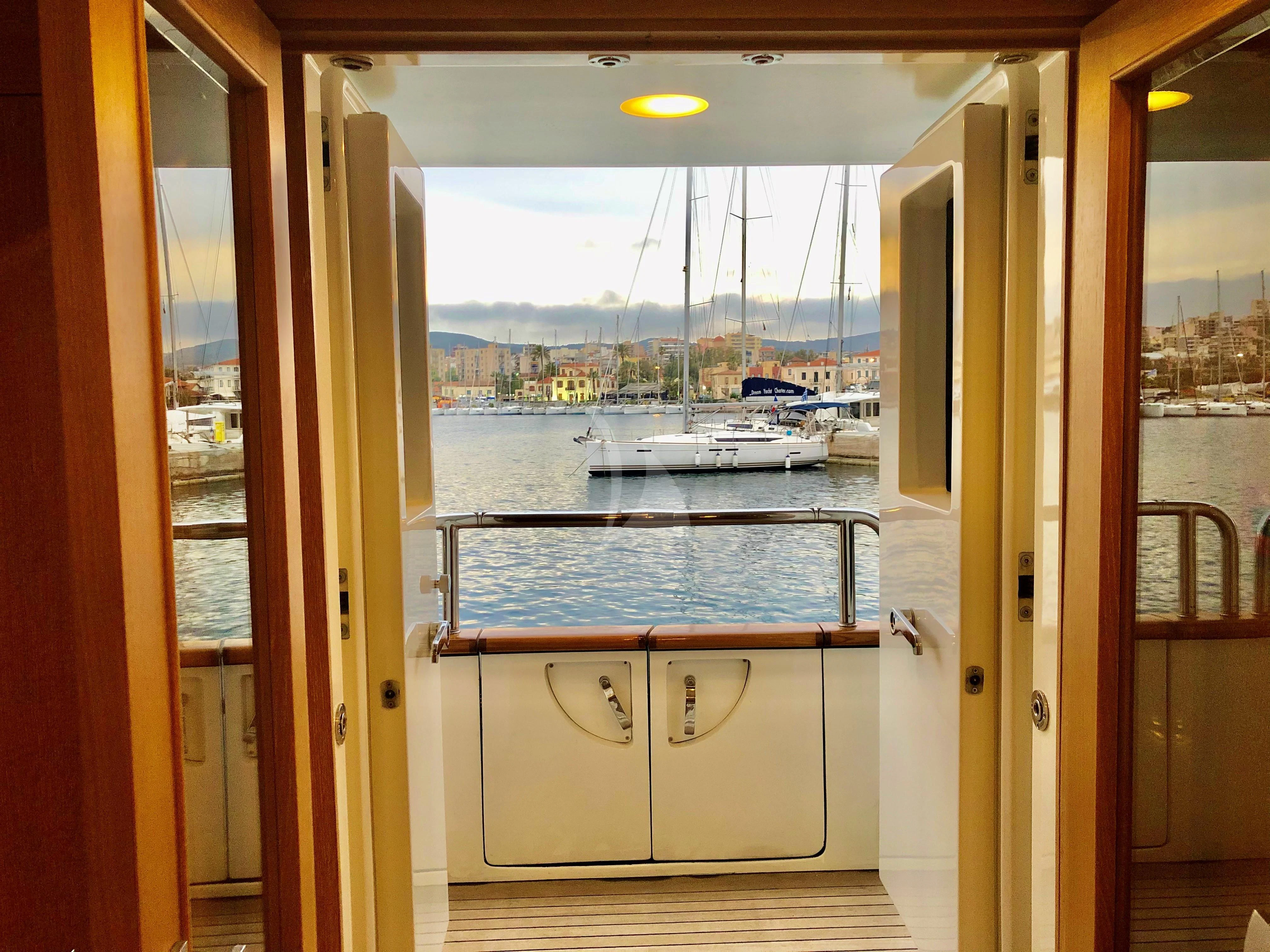 a room with a view of a city and water aboard GRANDE AMORE Yacht for Charter