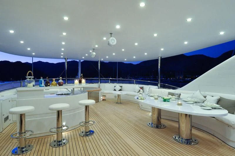 a room with tables and chairs aboard GRANDE AMORE Yacht for Charter