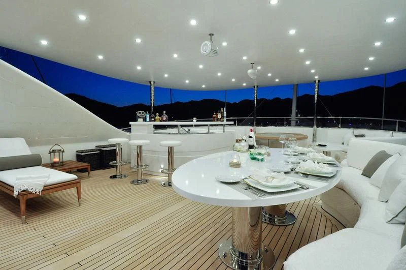 a room with tables and chairs aboard GRANDE AMORE Yacht for Charter