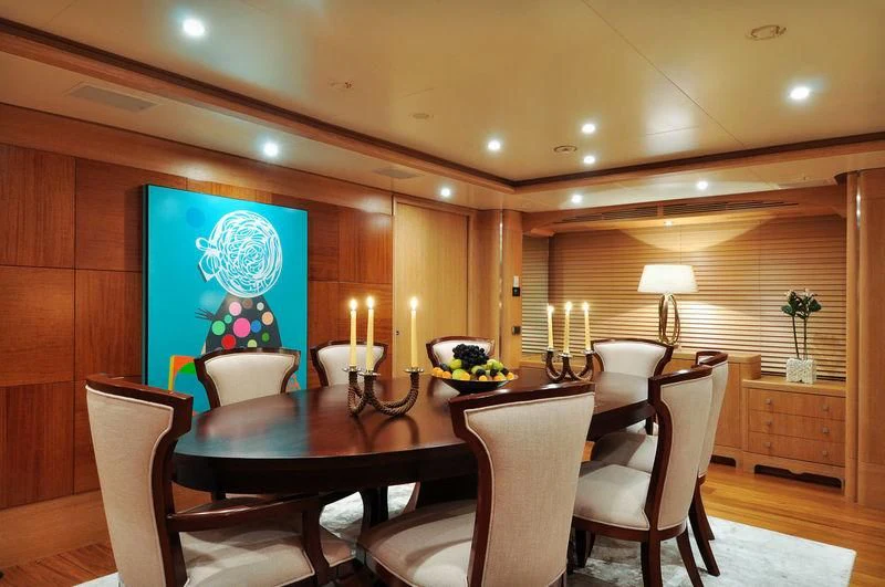 a dining room with a table and chairs aboard GRANDE AMORE Yacht for Charter