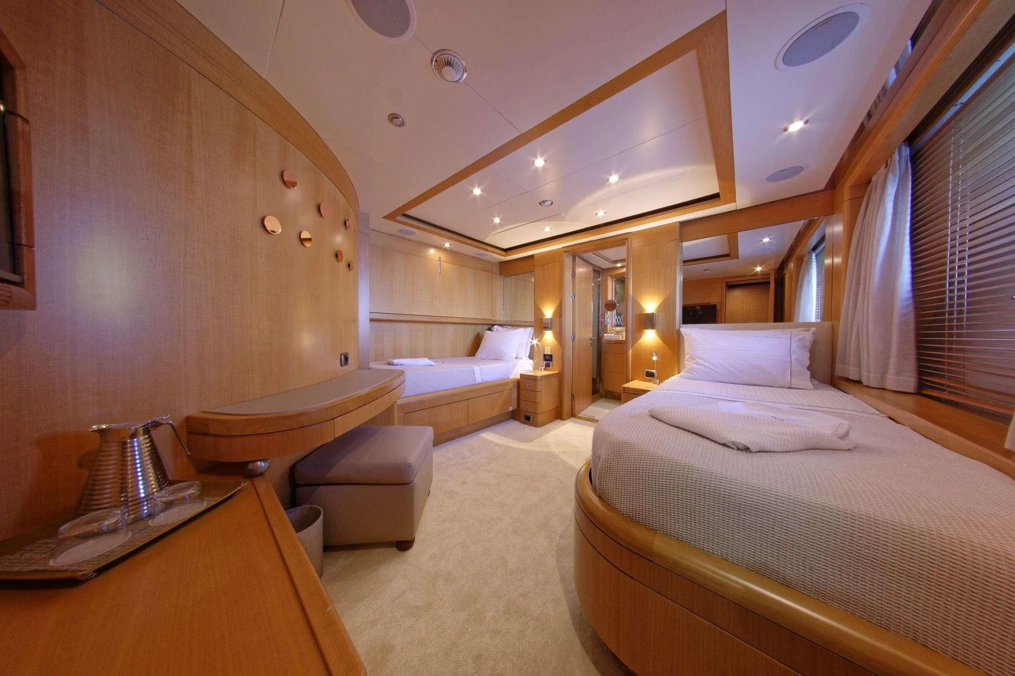 a room with a bed and a desk aboard GRANDE AMORE Yacht for Charter