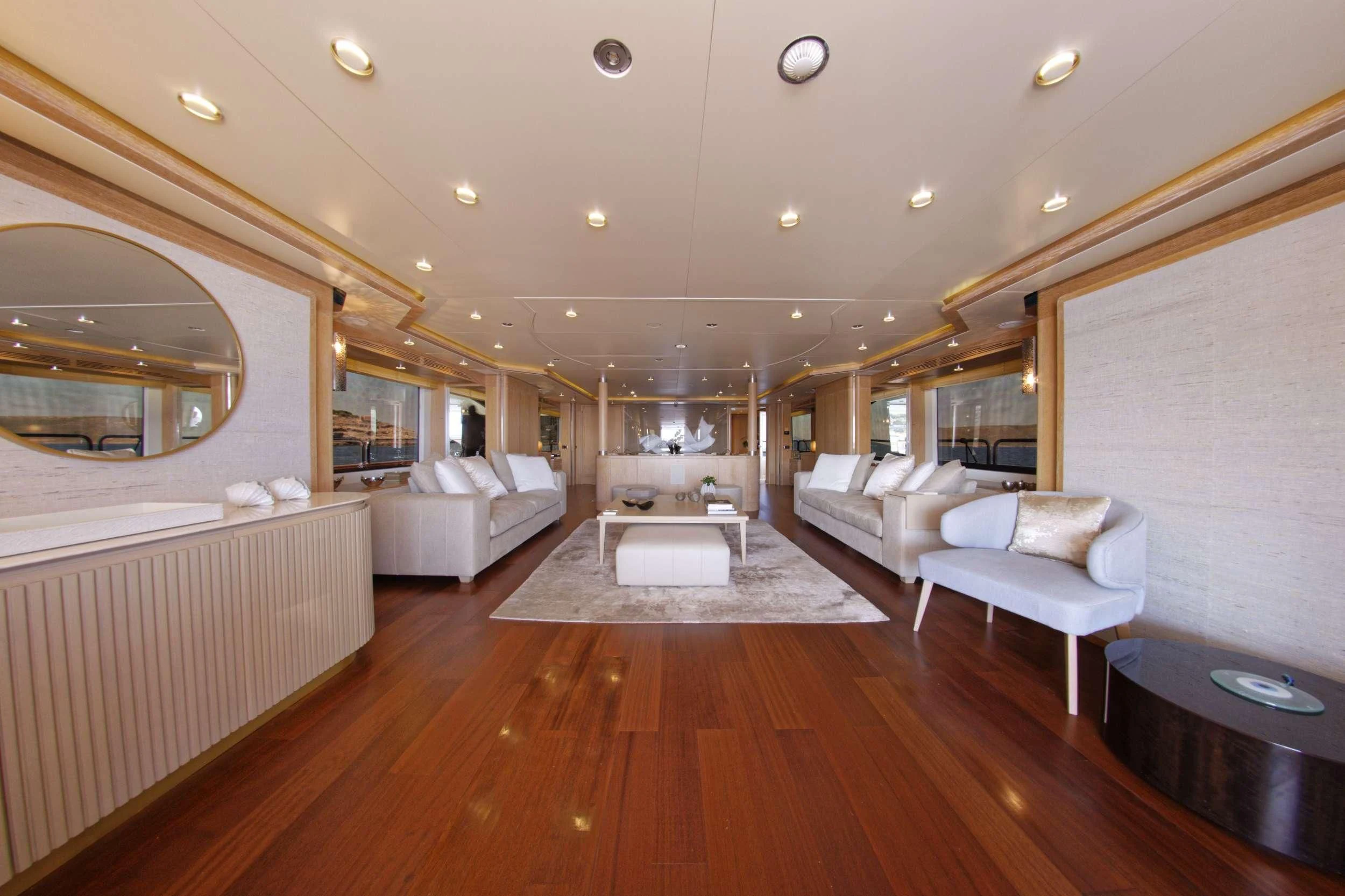 a large living room with a wood floor aboard GRANDE AMORE Yacht for Charter