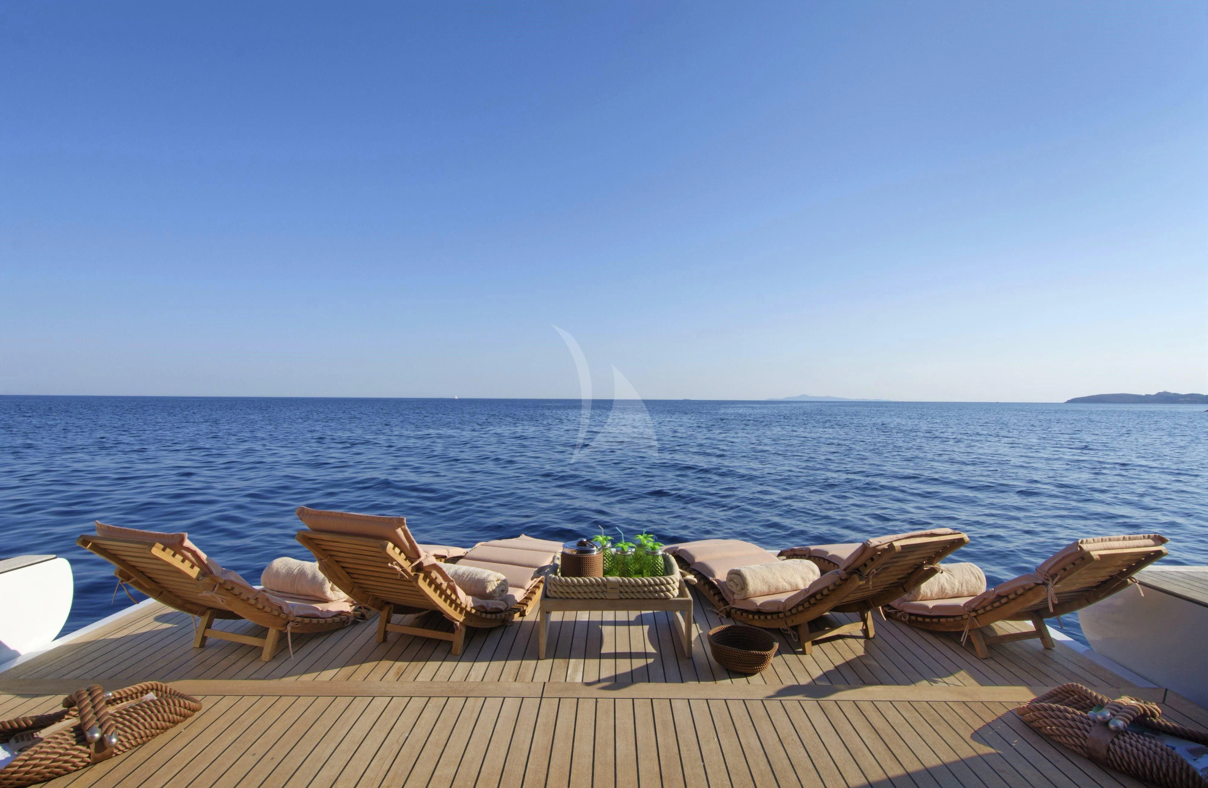 a deck with chairs and a fountain in the background aboard GRANDE AMORE Yacht for Charter