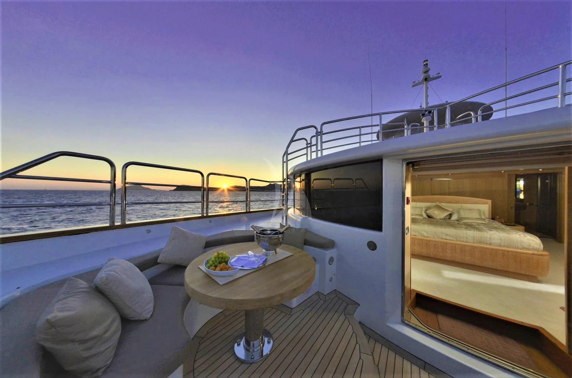 a room with a bed and a table on a boat aboard GRANDE AMORE Yacht for Charter
