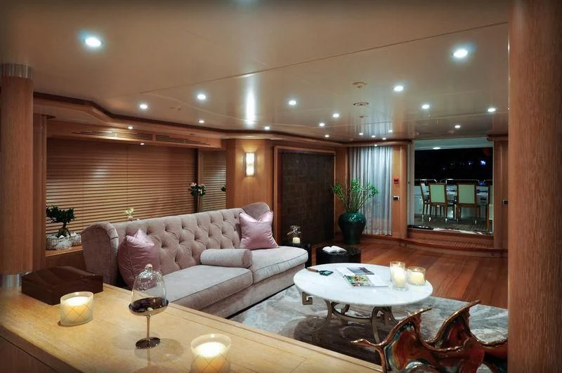 a living room with a large table and chairs aboard GRANDE AMORE Yacht for Charter