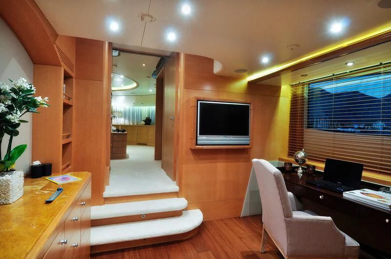 a room with a tv and a table aboard GRANDE AMORE Yacht for Charter