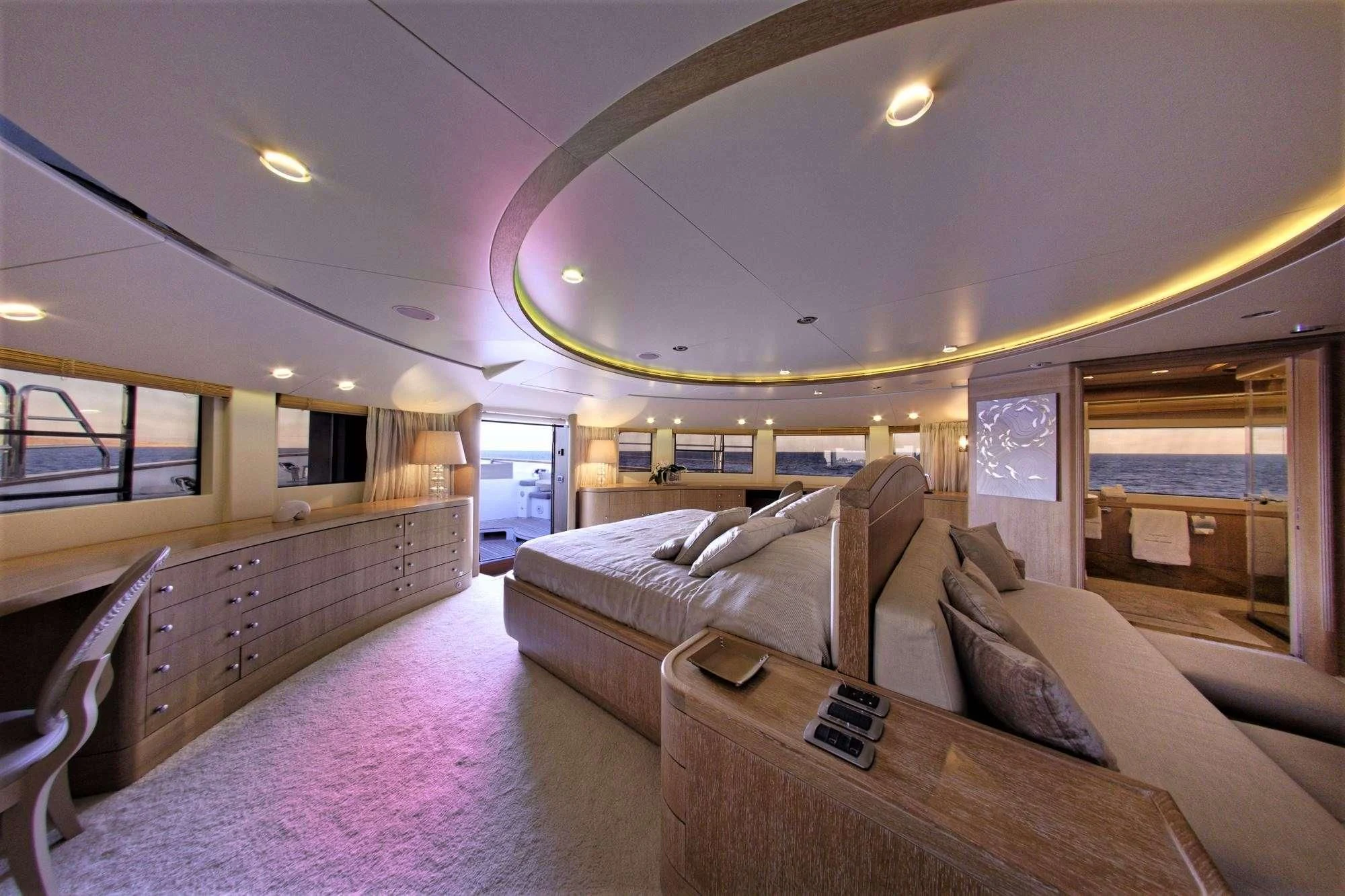 a large room with a bed and a couch aboard GRANDE AMORE Yacht for Charter