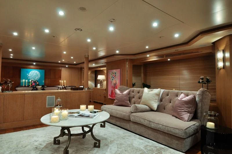 a living room with a couch and a table aboard GRANDE AMORE Yacht for Charter