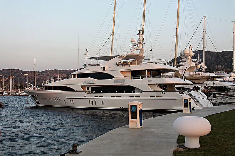 a white yacht docked at a dock aboard GRANDE AMORE Yacht for Charter