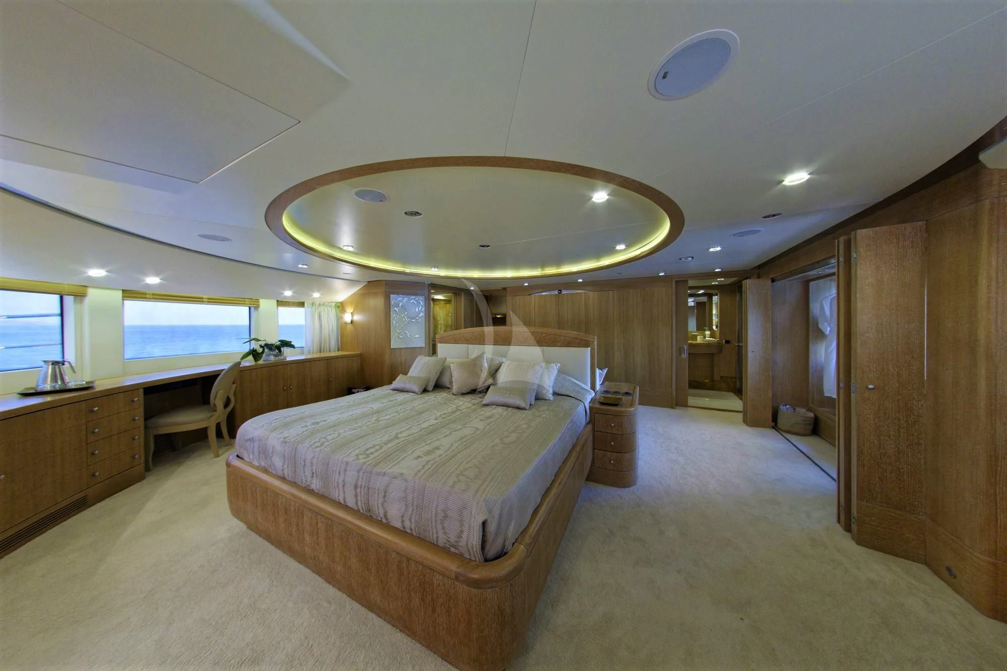 a large bedroom with a large mirror aboard GRANDE AMORE Yacht for Charter