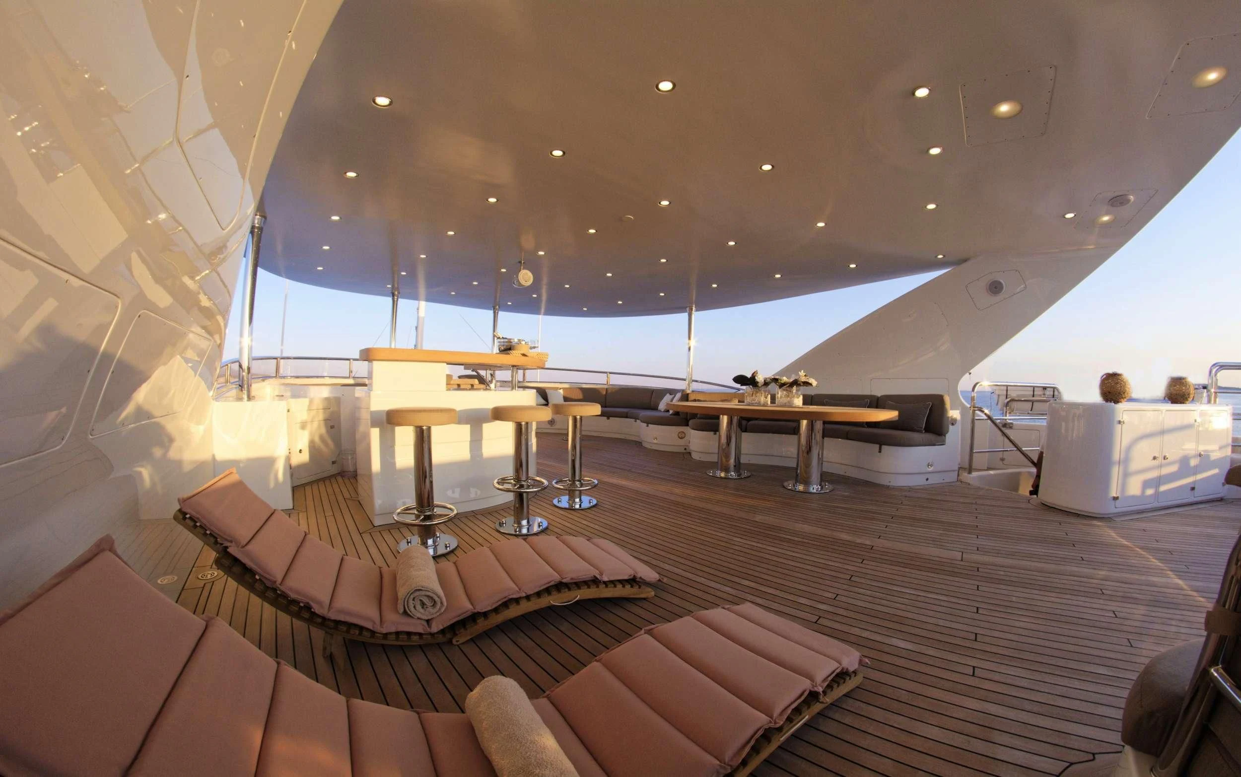 a room with a large deck and a pool aboard GRANDE AMORE Yacht for Charter