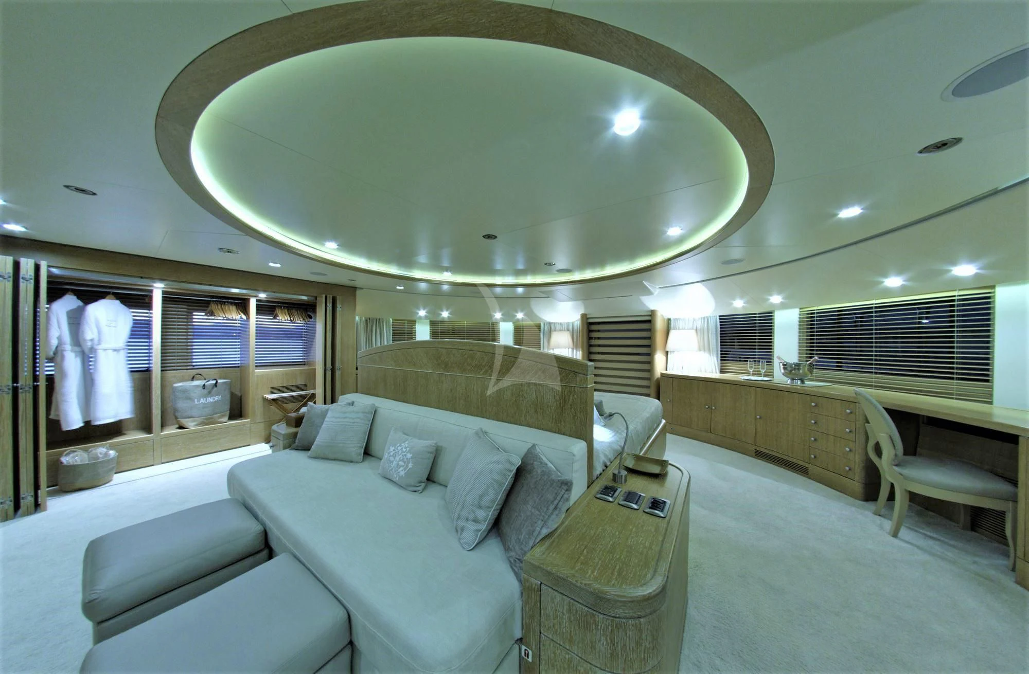 a large room with a bed and a large mirror aboard GRANDE AMORE Yacht for Charter