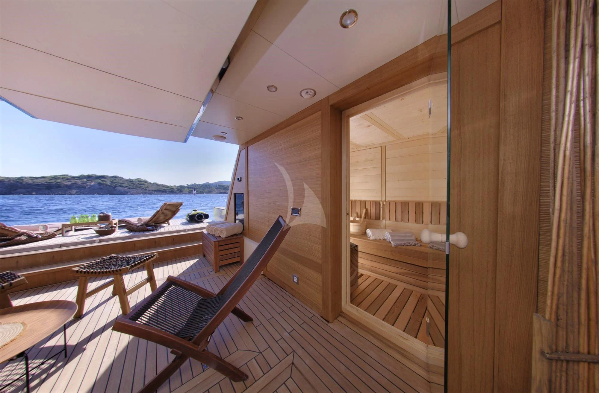a deck with a view of the water and the land below aboard GRANDE AMORE Yacht for Charter