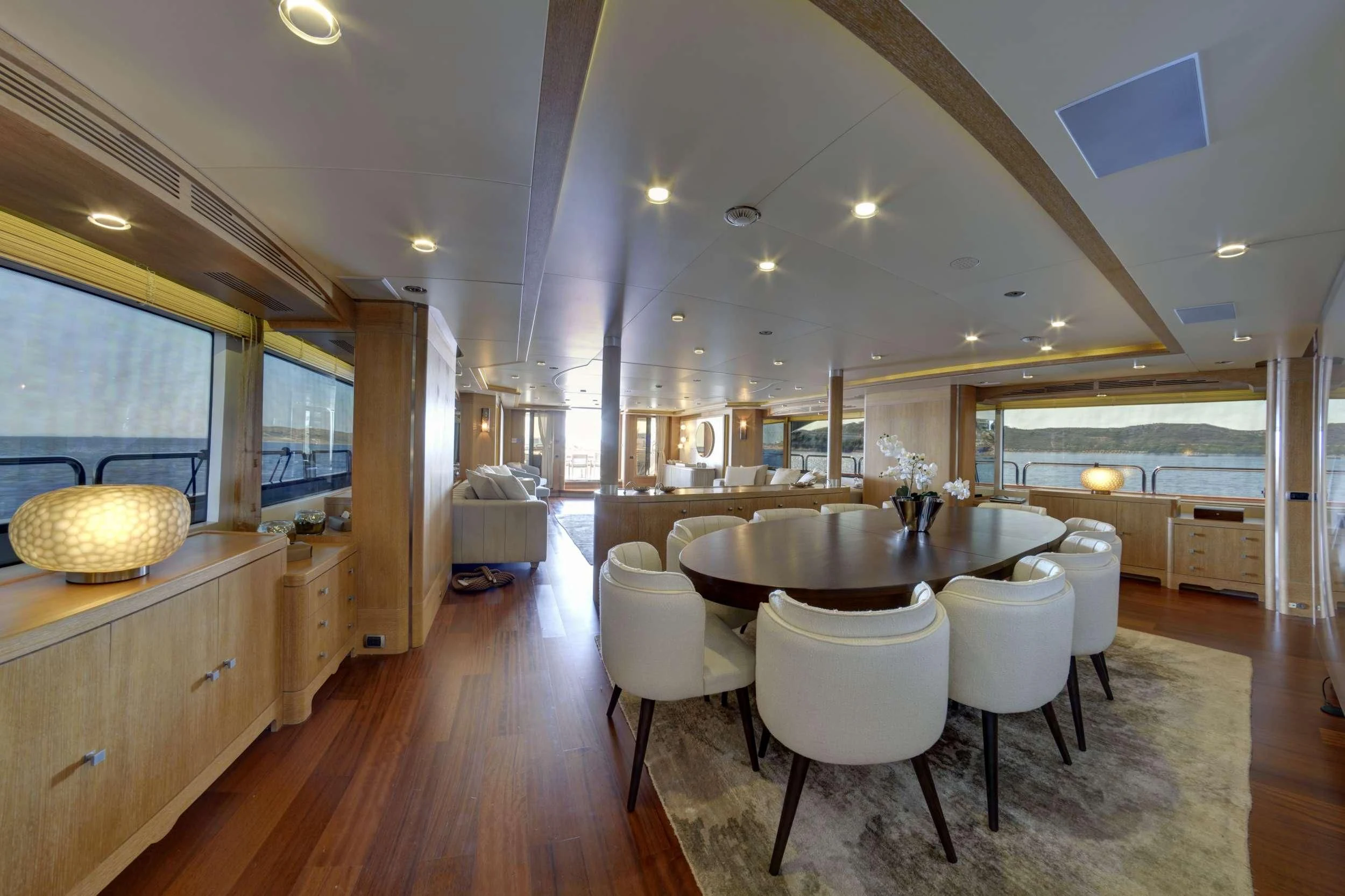 a large kitchen with a dining table aboard GRANDE AMORE Yacht for Charter