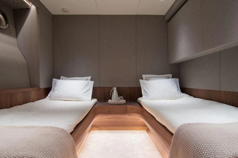 a room with beds and a lamp aboard WHISPER V Yacht for Sale