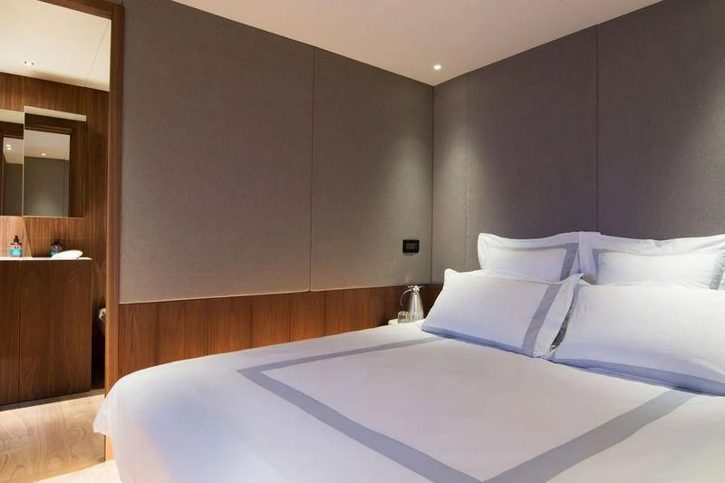 a bed with white sheets aboard WHISPER V Yacht for Sale