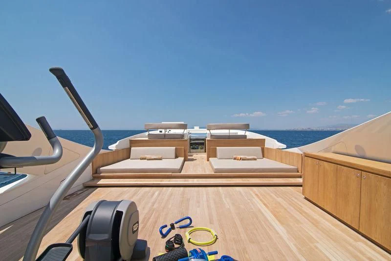 a deck with a view of the ocean and beach aboard WHISPER V Yacht for Sale