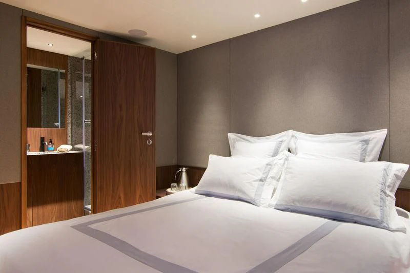 a bed with white sheets aboard WHISPER V Yacht for Sale