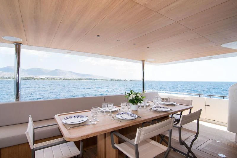a table with plates and glasses on it aboard WHISPER V Yacht for Sale