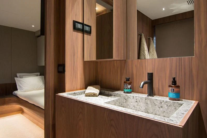 a bathroom with a sink and a mirror aboard WHISPER V Yacht for Sale