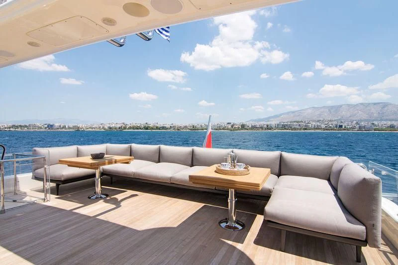 a room with a couch and a table and a view of a city aboard WHISPER V Yacht for Sale