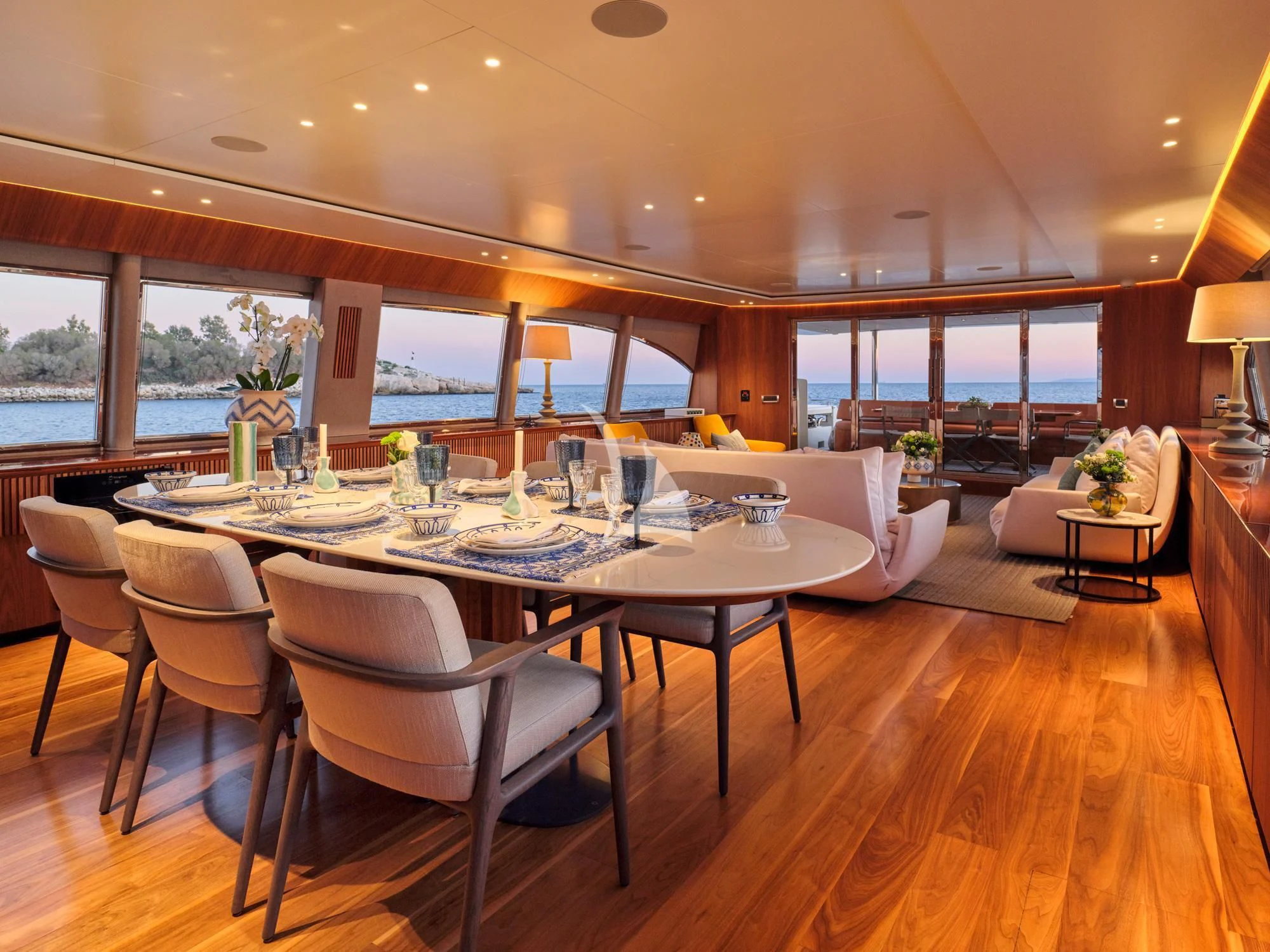 a large dining table with white chairs aboard WHISPER V Yacht for Sale