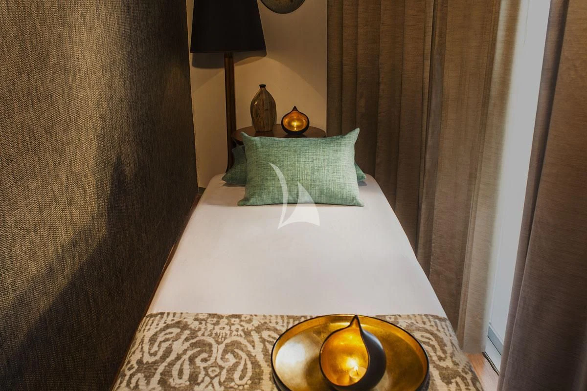 a bed with a fireplace aboard ARIA AMAZON Yacht for Sale