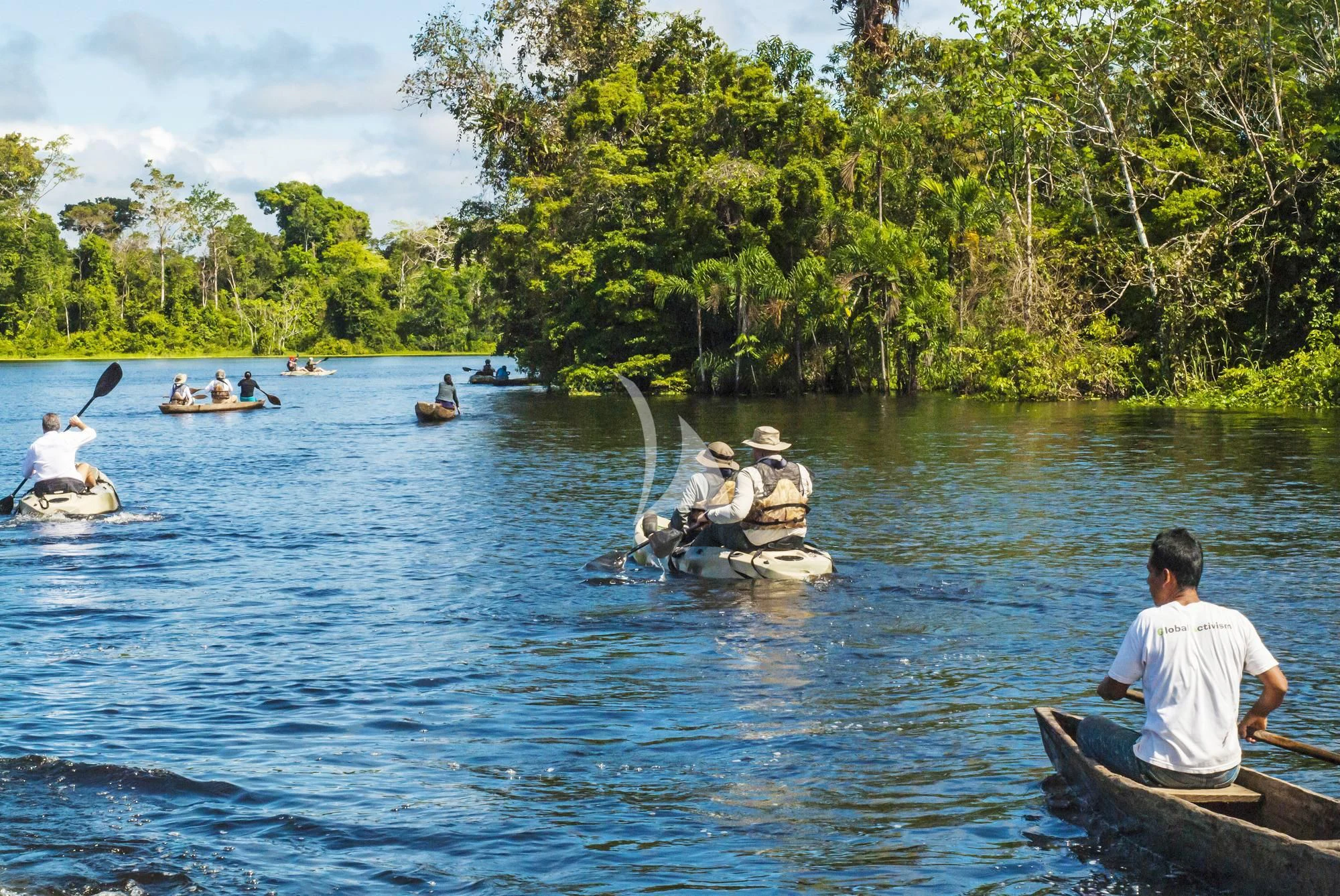 a group of people rowing boats on a lake aboard ARIA AMAZON Yacht for Sale