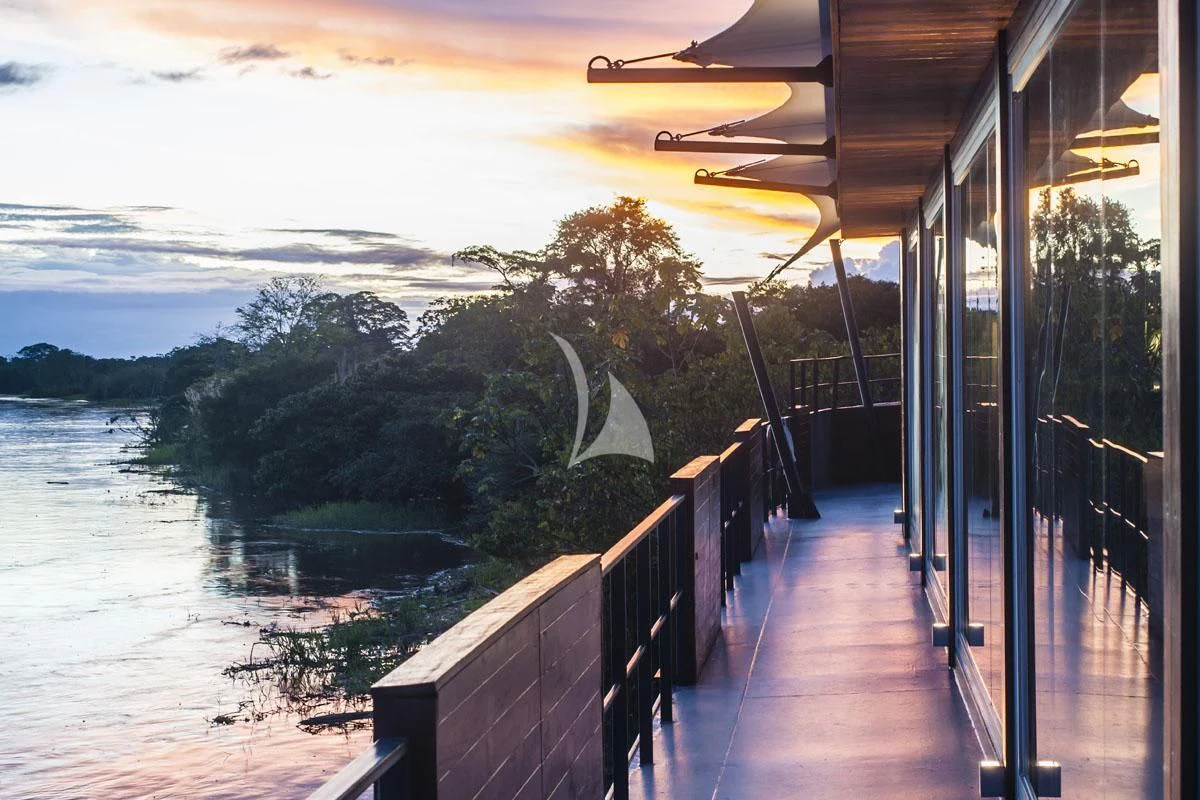a deck with a body of water and trees on the side aboard ARIA AMAZON Yacht for Sale