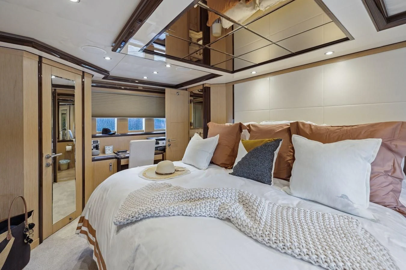 a bed with a white bed spread aboard RELENTLESS Yacht for Sale