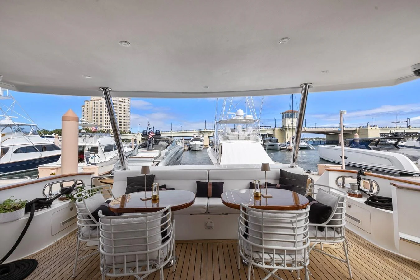 a deck with a table and chairs on it aboard RELENTLESS Yacht for Sale