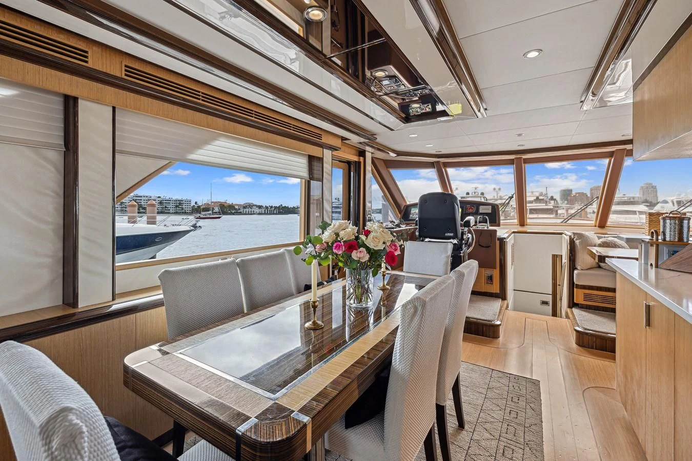 inside of a boat with a table and chairs and a large window aboard RELENTLESS Yacht for Sale