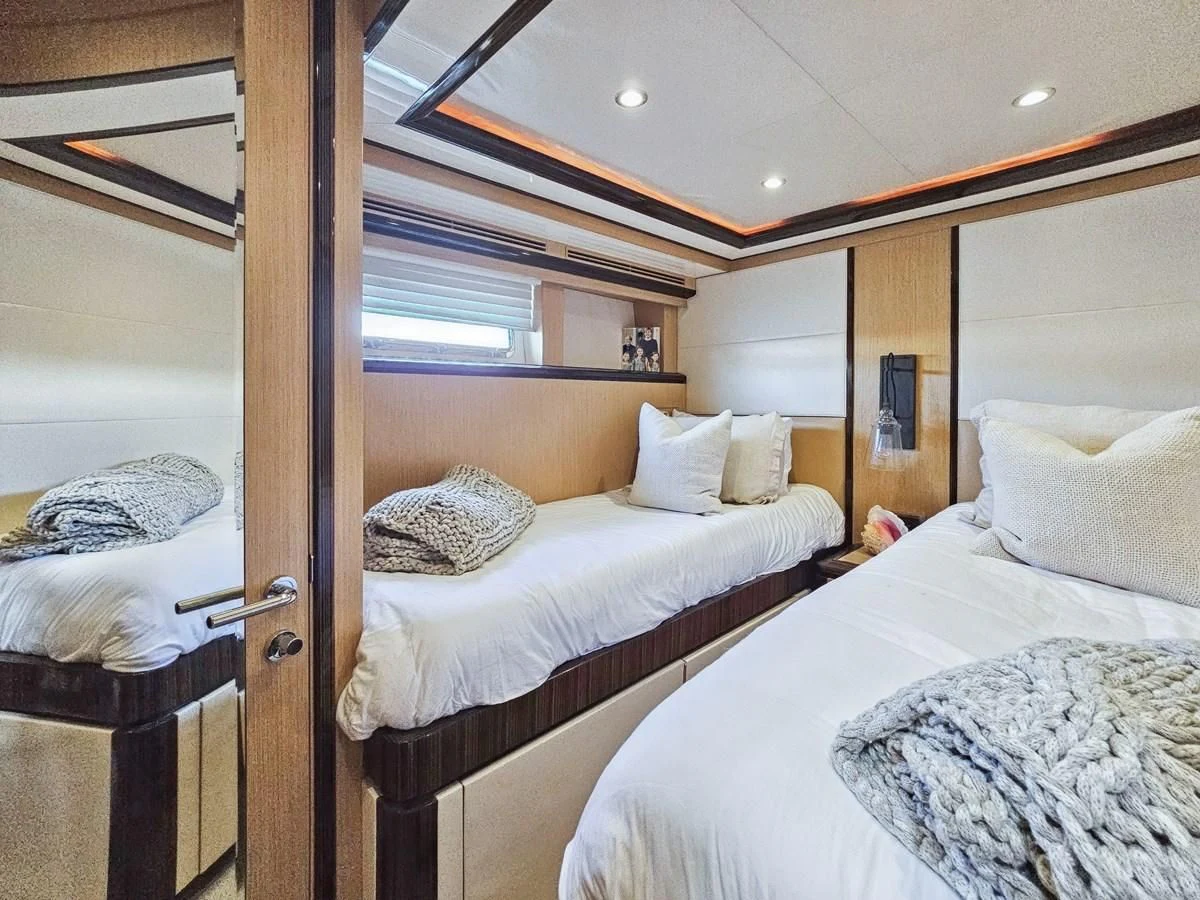a couple of beds in a room aboard RELENTLESS Yacht for Sale