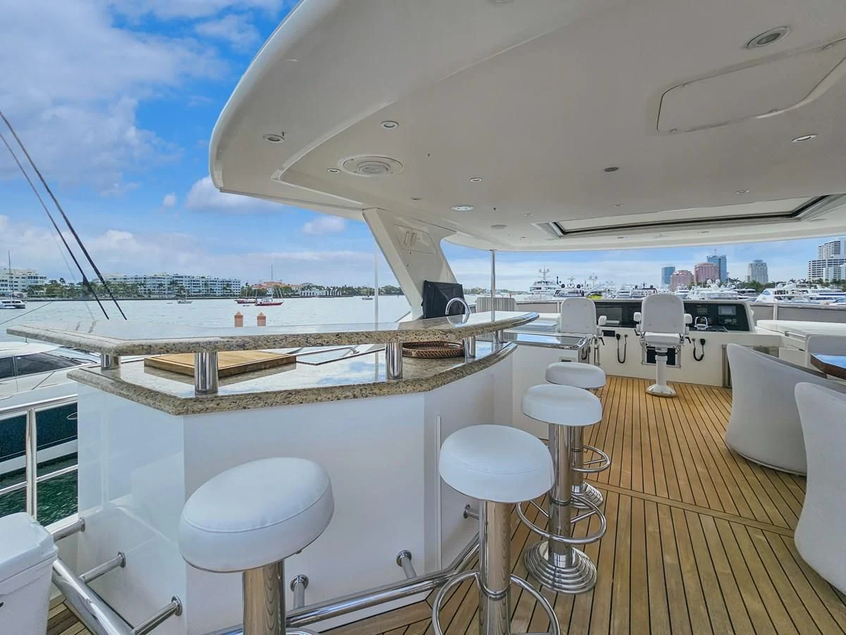 a boat with stools and tables aboard RELENTLESS Yacht for Sale