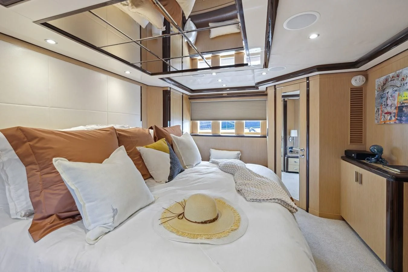 a bed with a white comforter and pillows aboard RELENTLESS Yacht for Sale