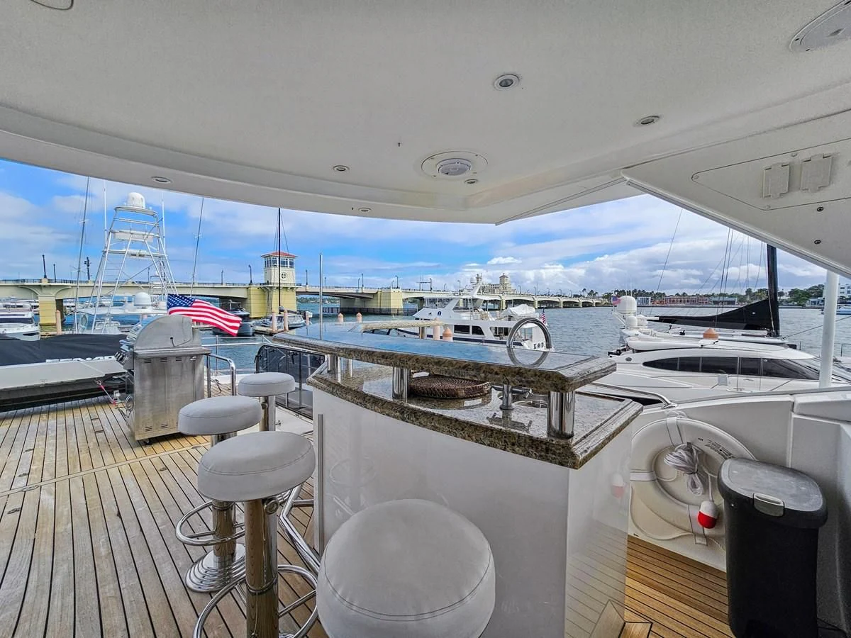 a boat with a deck and a deck and a deck with a view of the water aboard RELENTLESS Yacht for Sale