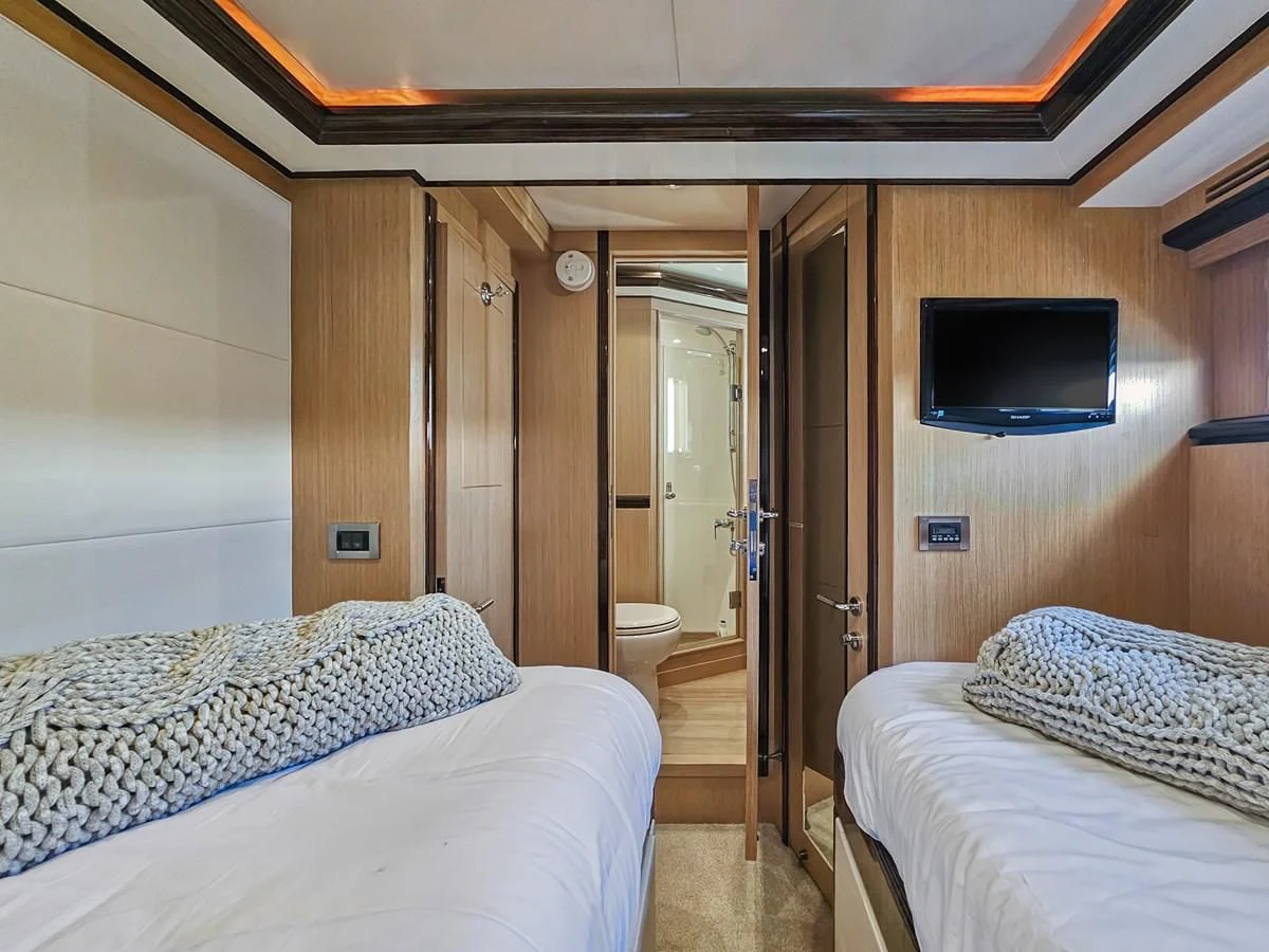 a room with two beds aboard RELENTLESS Yacht for Sale