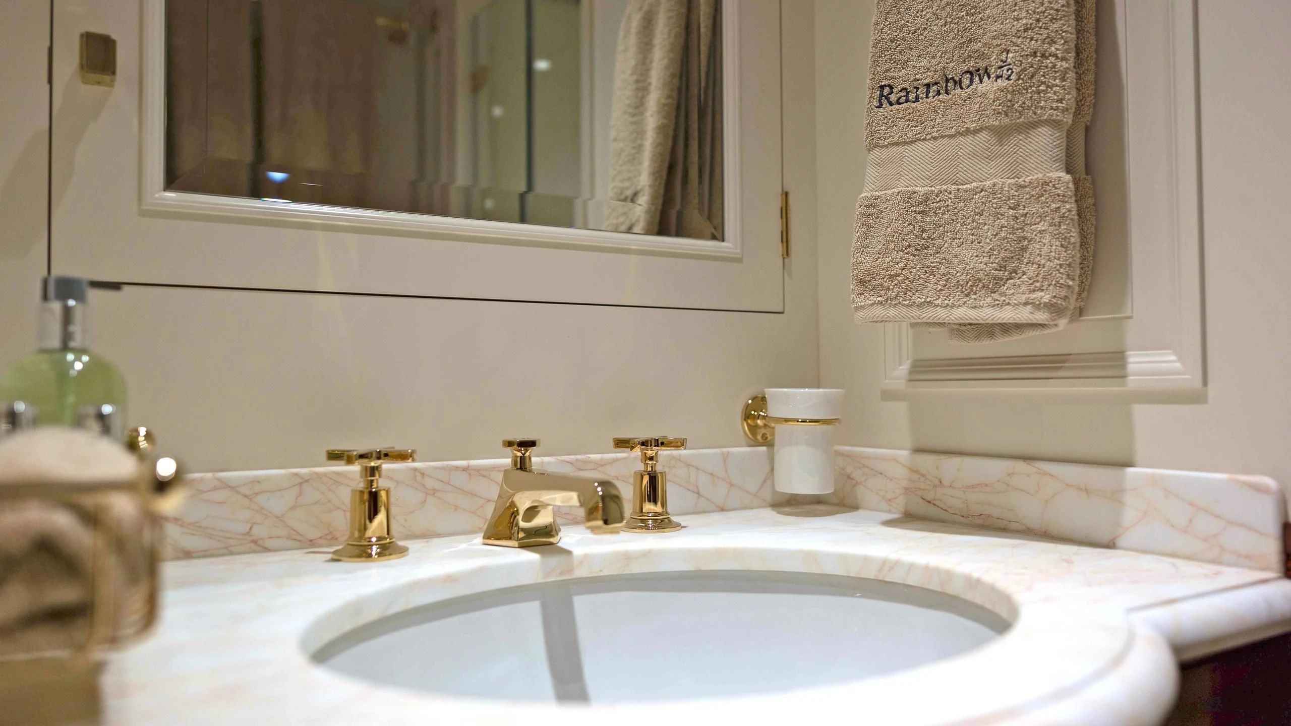 a bathroom sink with towels and towels aboard RAINBOW Yacht for Sale