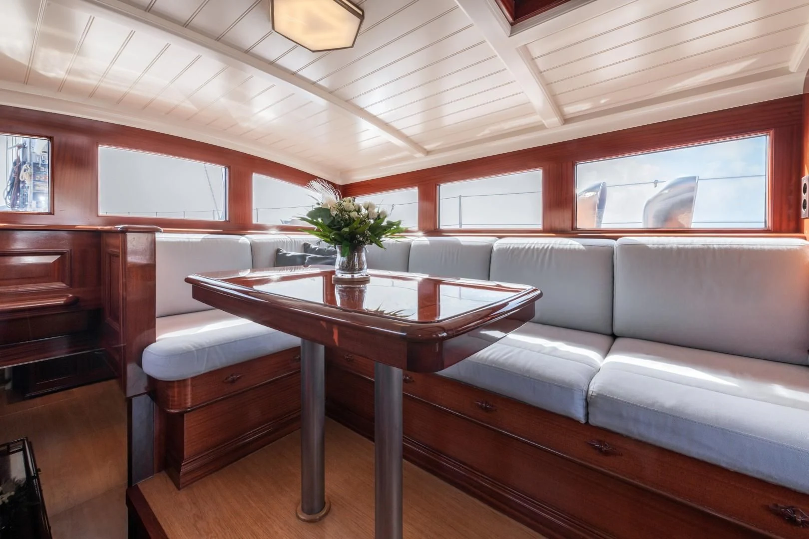 a living room with a couch and a coffee table aboard RAINBOW Yacht for Sale