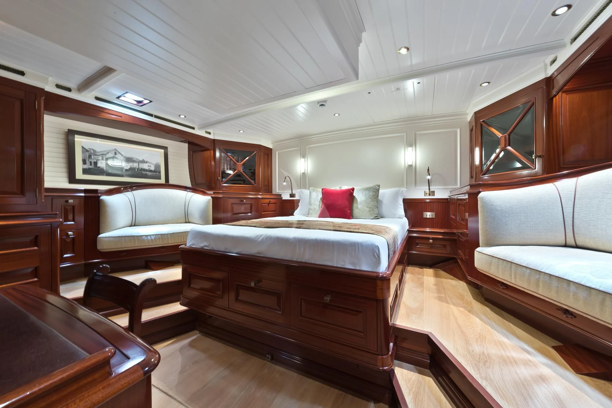 a room with a bed and a couch aboard RAINBOW Yacht for Sale