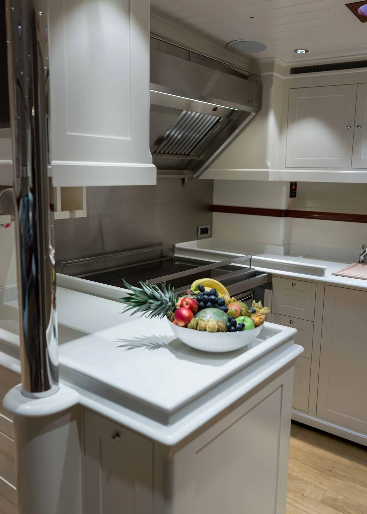 a kitchen with a bowl of fruit aboard RAINBOW Yacht for Sale