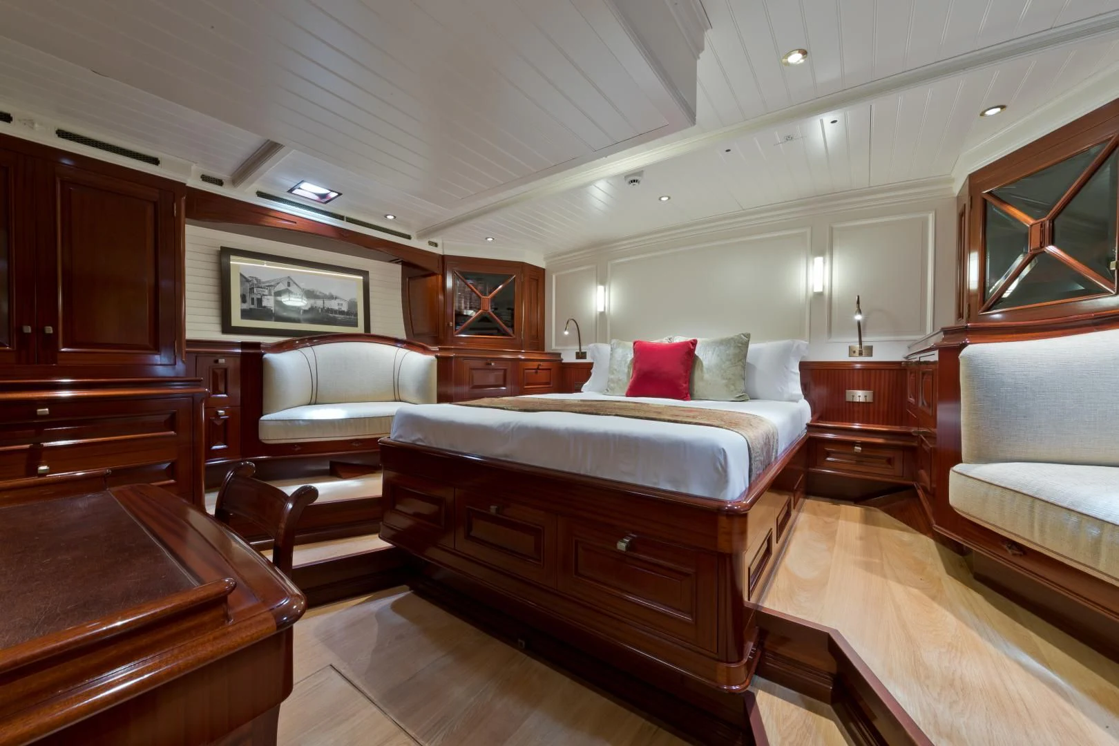a bedroom with a bed and a couch aboard RAINBOW Yacht for Sale